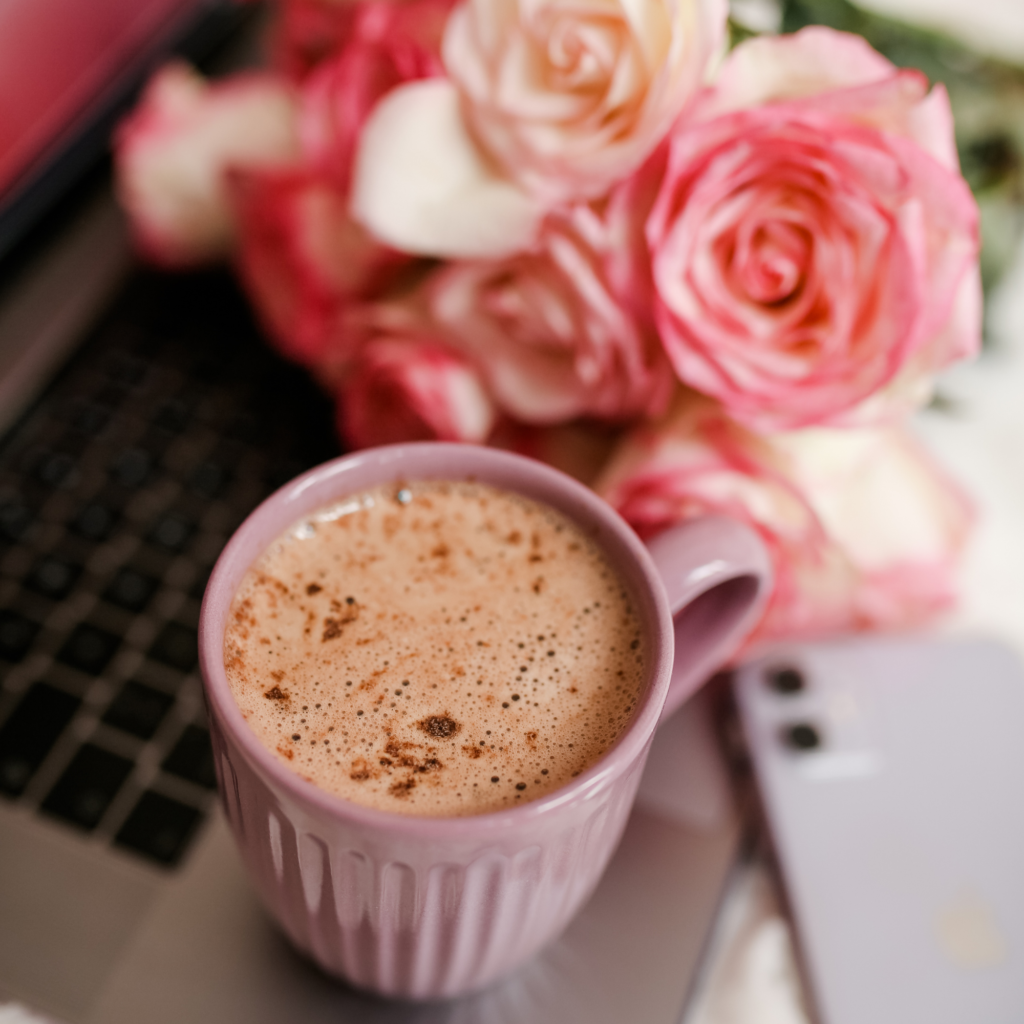 coffee cup and roses on laptop